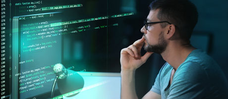 Man at a computer reviewing code